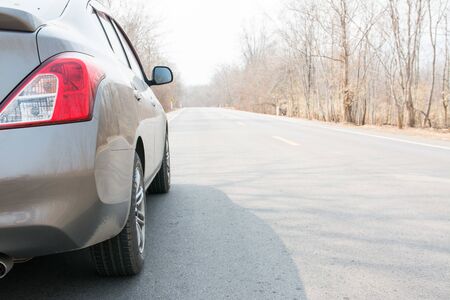 Car on Asphalt road in Autumn forestの写真素材