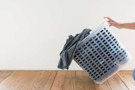 Laundry basket on floor and white backgroundの写真素材