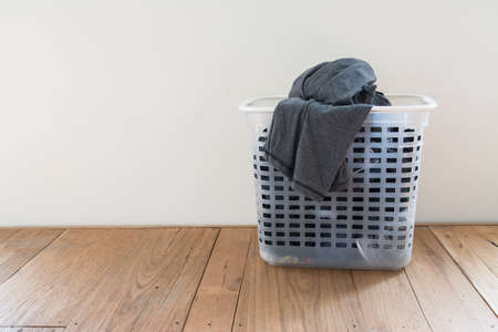 Laundry basket on floor and white backgroundの写真素材