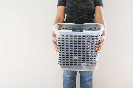 Women with laundry basket on floor and white background