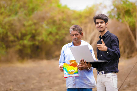 young indian farmer with agronomist