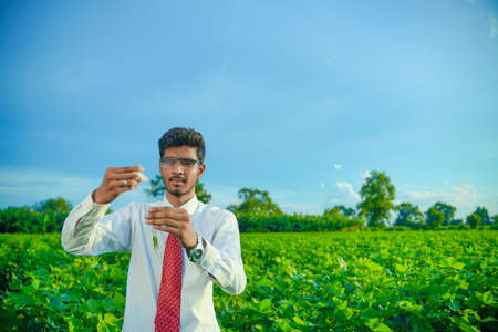 Young indian agronomist with test tube, Agriculture and scientist concept.の写真素材