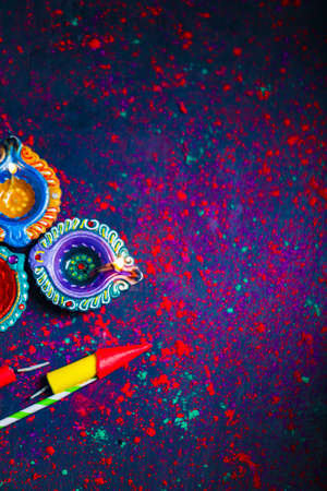 Diwali Diya with Fire Crackers over rangoli backgroundの写真素材