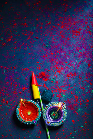 Diwali Diya with Fire Crackers over rangoli backgroundの写真素材