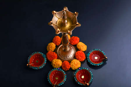 Colorful clay diya lamps lit during diwali celebrationの写真素材