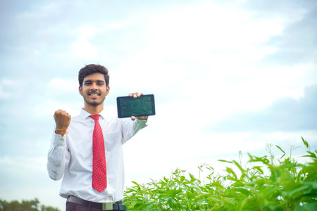 agronomist at green Cotton field and showing tab screenの写真素材