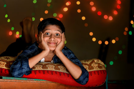 Cute indian little child showing expression over lighting background