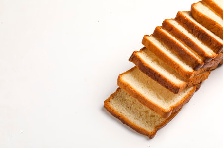 Cut of loaf bread on white against white backgroundの写真素材