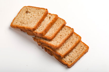 Cut of loaf bread on white against white background