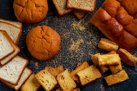 Bakery product, crispy and dry khari or puff,rusk and bun with copy (tex) space over dark backgroundの写真素材