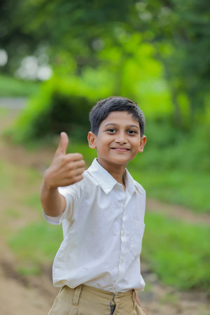 little Indian / Asian boy showing thumbs upの写真素材