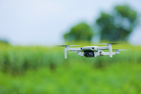 Close up view of flying drone over agriculture fieldの写真素材