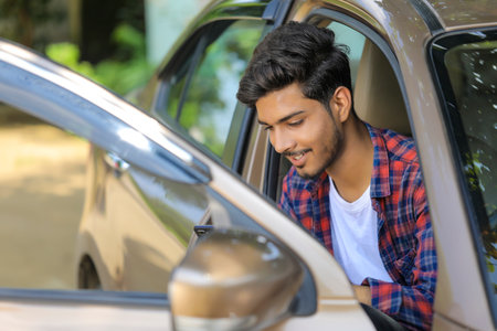 Young indian man with his carの写真素材