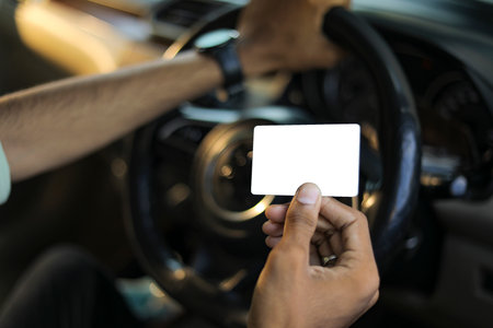Business man showing his blank business card / credit card inside car