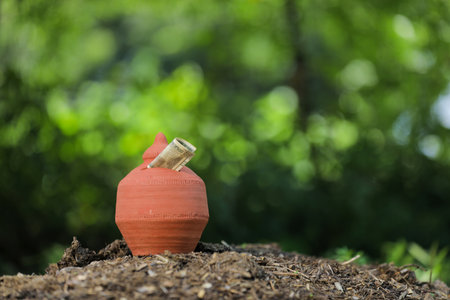Indian rupees symbol and clay piggy bankの写真素材