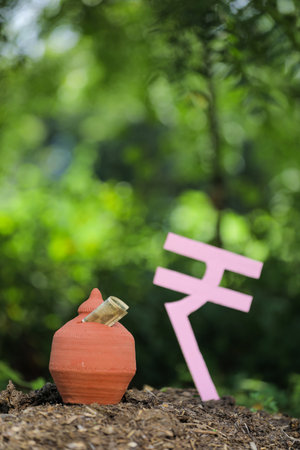 Indian rupees symbol and clay piggy bankの写真素材