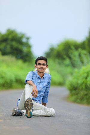 Young indian man showing expression over nature background