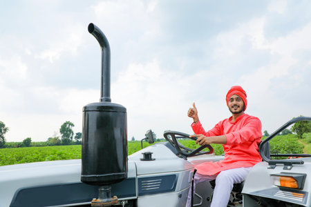 Indian farmer working with tractor at fieldの写真素材