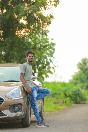 Young indian man showing expression over nature backgroundの写真素材