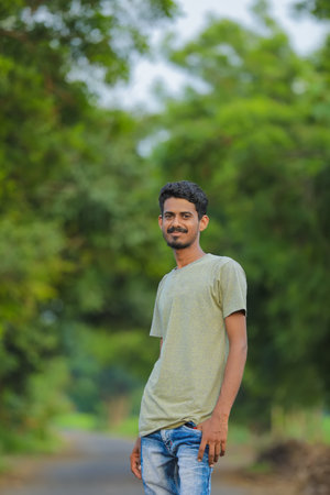 Young indian man showing expression over nature backgroundの写真素材