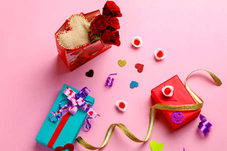 Little heart, red rose flower and gift box on pink background. Valentine day conceptの写真素材