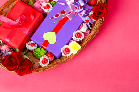 Little heart, red rose flower and gift box on pink background. Valentine day concept