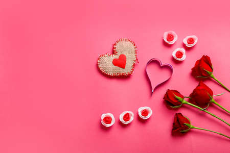 Little heart, red rose flower and gift box on pink background. Valentine day conceptの写真素材