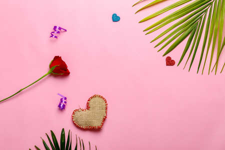 Little heart, red rose flower and gift box on pink background. Valentine day conceptの写真素材