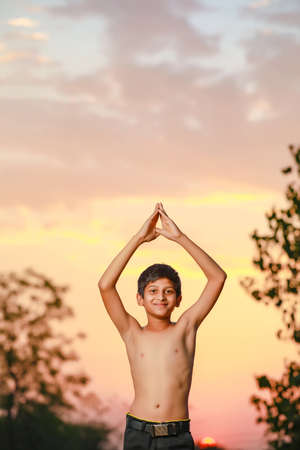 the indian priest child doing meditationの写真素材