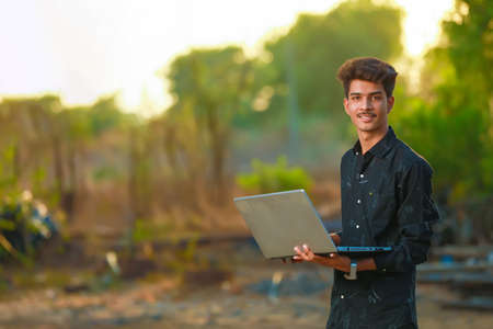 Young indian boy using laptopの写真素材