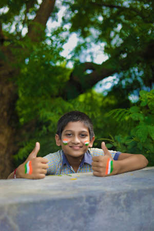 young indian child with indian flag on faceの写真素材