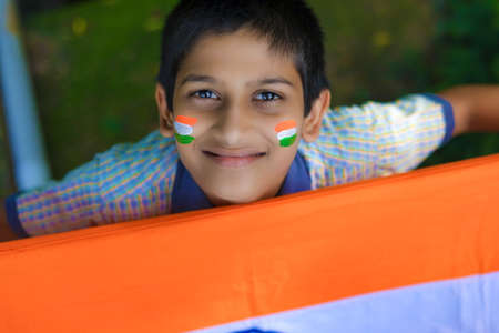 young indian child with indian flag on face