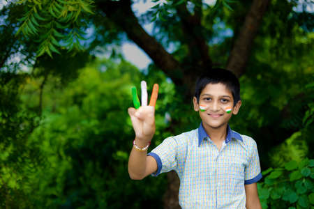 young indian child with indian flag on faceの写真素材