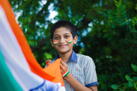 young indian child with indian flag on faceの写真素材