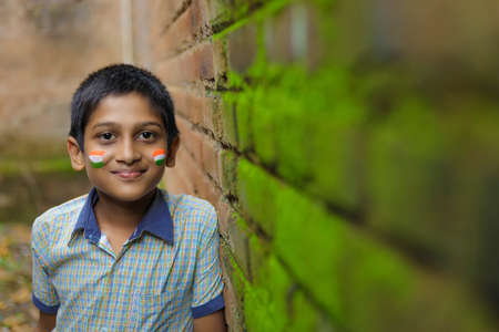 young indian child with indian flag on faceの写真素材