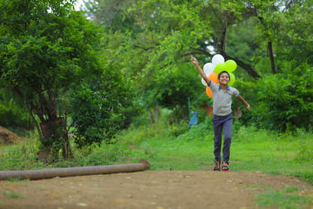 young indian child with tricolor balloon