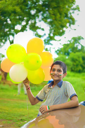 young indian child with tricolor balloon