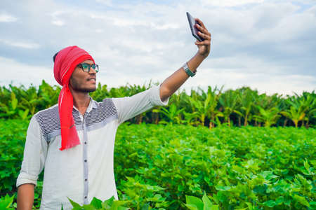 young indian farmer take selfie in smartphone