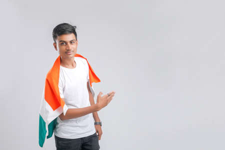 Young indian man with indian flagの写真素材