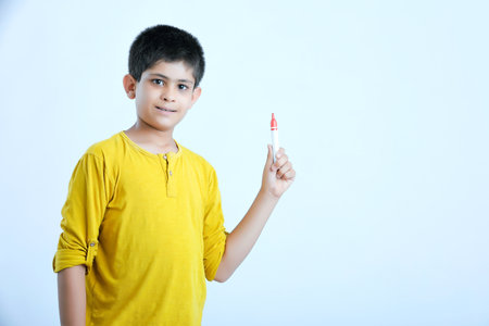 young indian child showing a pen, markerの写真素材