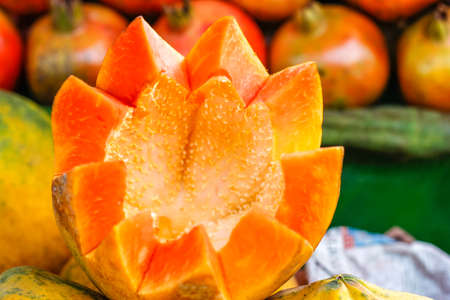 Fresh Papaya cut in flower shape and heap papaya bunch