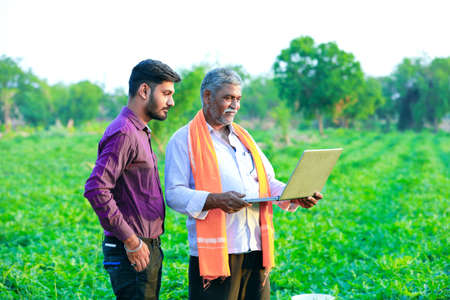 indian agronomist with farmer at fieldの写真素材