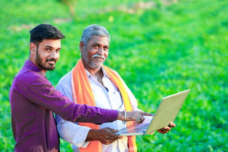 indian agronomist at field with farmerの写真素材