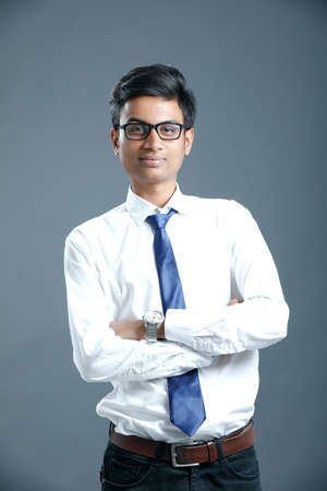 young indian employee wear spectacles and giving expression