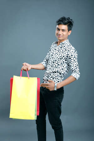 Young Indian man with shopping bagsの写真素材