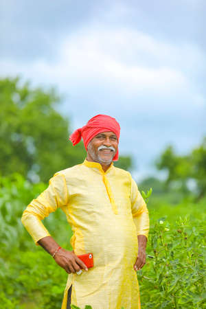 Indian / Asian farmer standing at agriculture fieldの写真素材