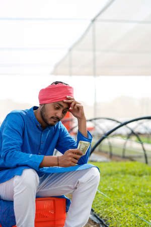 Young Indian farmer in depression.の写真素材