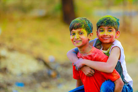 Holi celebrations -Indian little boy playing Holi and showing face expression.の写真素材