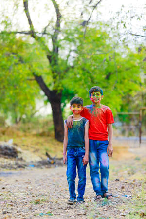 Cute indian little child playing holi. Holi is colors festival in india