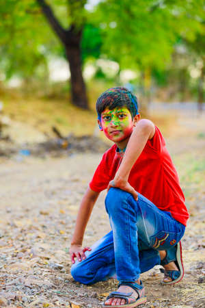 Holi celebrations -Indian little boy playing Holi and showing face expression.